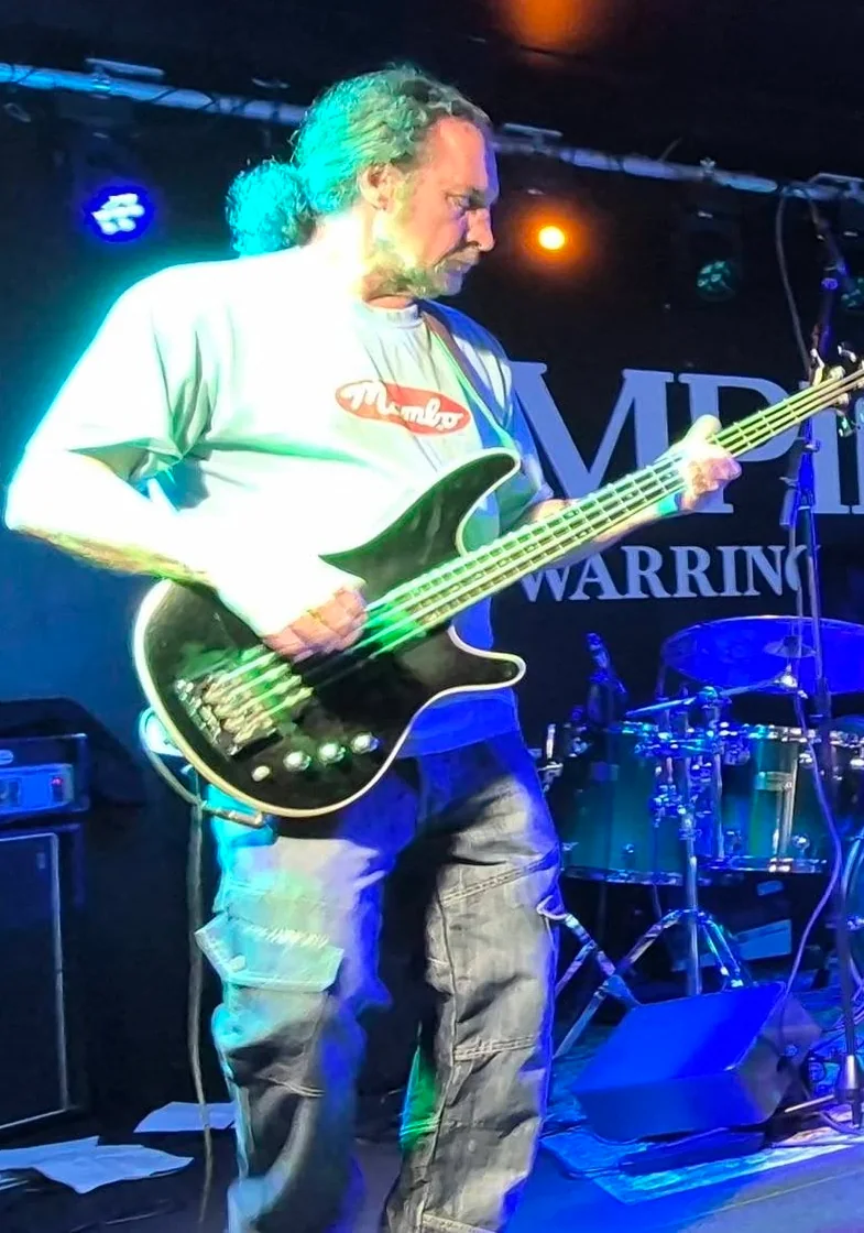 Neil Isherwood playing bass guitar