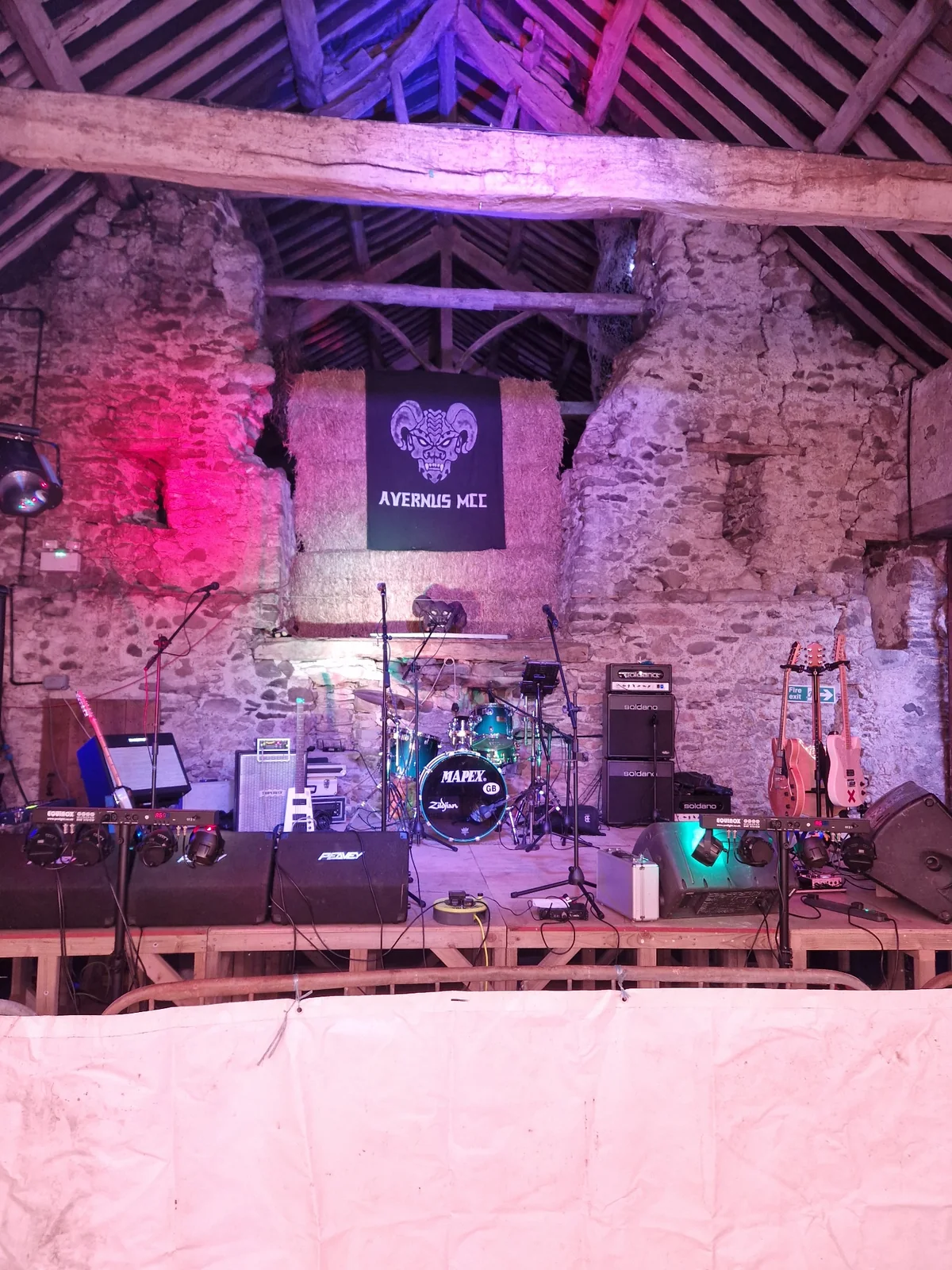 Electric Outlawz stage setup in a stone barn venue