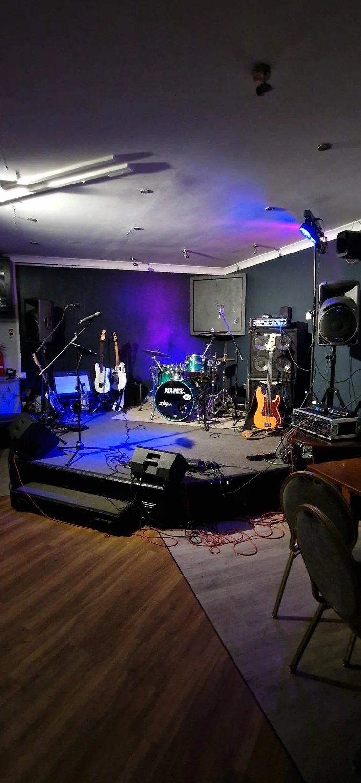Electric Outlawz stage setup under blue lighting for a private birthday party